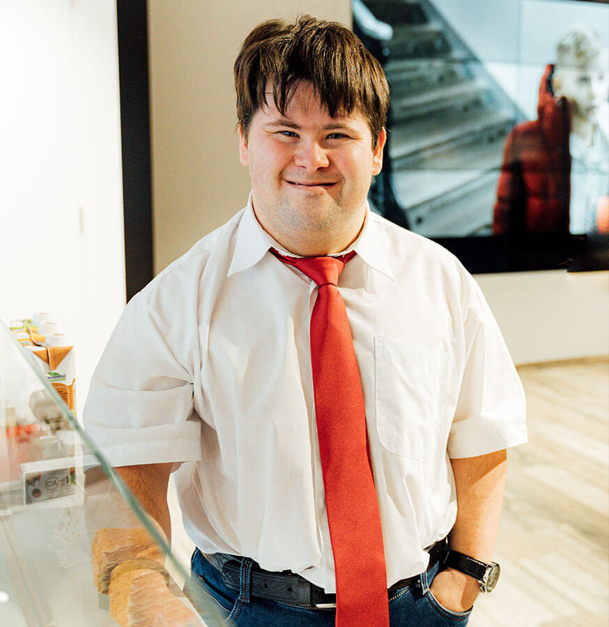 man with down syndrome dressed formally at work